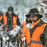 Hunters Hunting in winter wearing blaze orange hunting clothing
