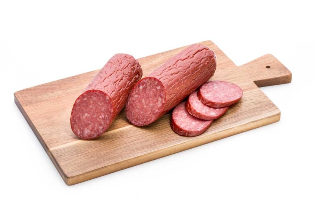 venison summer sausage on wooden cutting board | Hunting Magazine