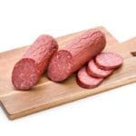 venison summer sausage on wooden cutting board | Hunting Magazine