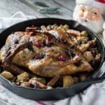 holiday roast baked duck on roasted vegetables in cast iron pan with cranberries | Hunting Magazine