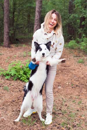 Woman Happy with Her Dog After Treating Dog Anxiety with Black Oak Pet CBD - Hunting Magazine