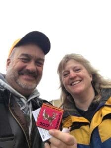 Rep. Rick Hansen (left) and Dr. Michelle Carstensen, Minnesota DNR (right), with a 2017 DNR “cooperator” patch after testing wild deer for chronic wasting disease. Source - Rep. Rick Hansen - Hunting Magazine