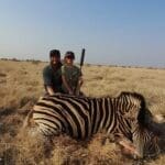 Proud Young Hunter Shoots Zebra in Africa