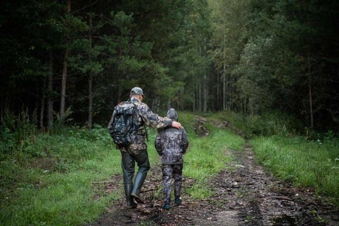 Father and Son head out hunting after checking their hunting licenses